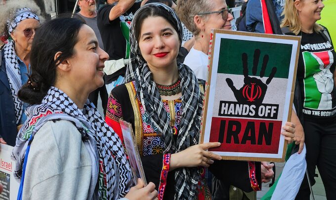Two women protesters with a “Hands off Iran” placard at yesterday’s Auckland rally