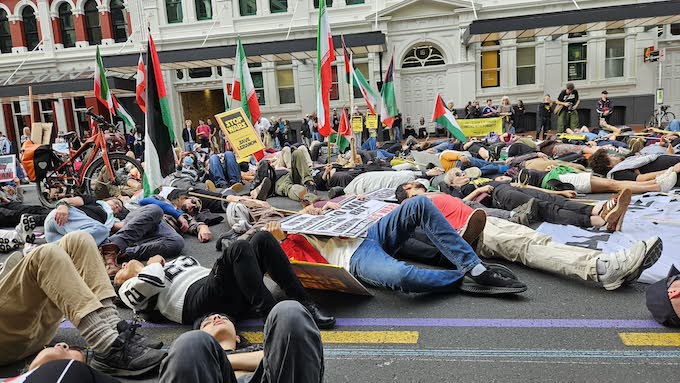 Protesters in the “die-in” in the street outside the US Consulate in Auckland