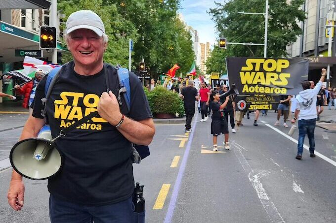 Palestine Solidarity Network Aotearoa's Neil Scott and protesters marching in the Stop Wars Aotearoa rally in Auckland's Queen Street