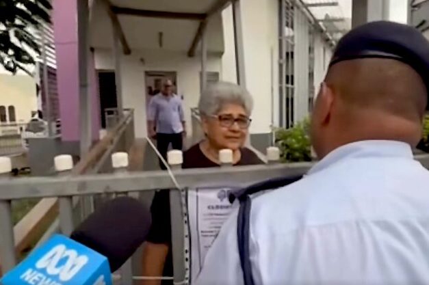 Fiji police talk to a Palestine protest organiser, Fiji Women's Crisis Centre coordinator Shamima Ali